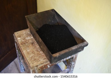 Man Cleaning Wood Burning Stove. Cleaning A Stove For Central Heating