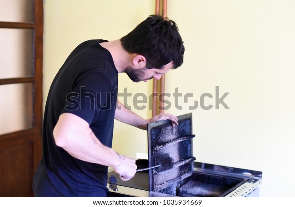 Man Cleaning Wood Burning Stove Cleaning Miscellaneous Stock Image