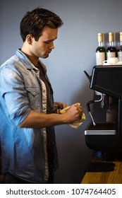 A Man Is Cleaning A Workstation In A Coffee House