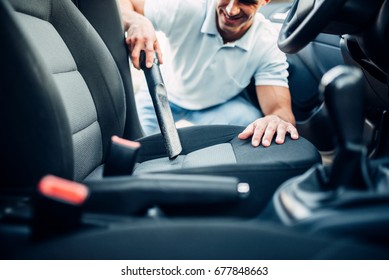 Man Cleans Car Interior With Vacuum Cleaner