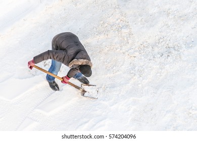 Man Cleans Snow Shovel, Top View