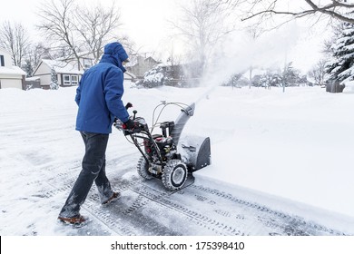 Man Clearing Snow with a Snow Blower