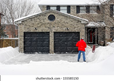 Man Clearing Snow On His Driveway