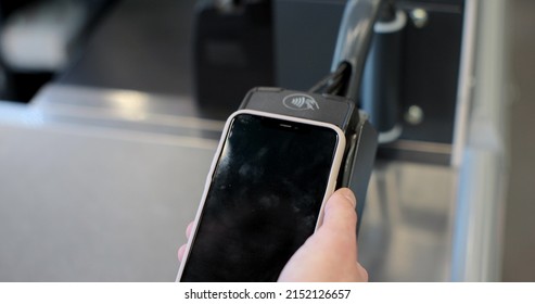 Man Client Hand On Pos-terminal Seller Or Store Employee In Food Supermarket Closeup. Pay By Phone On Electronic Payment Machine Or Card Reader.