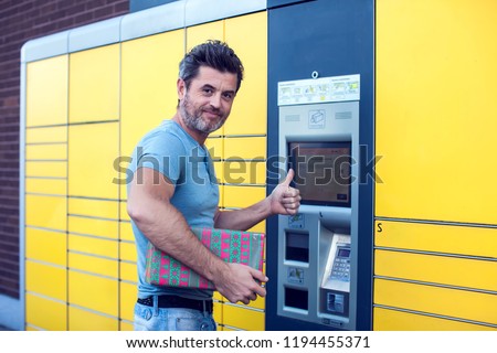 man client using automated self service post terminal machine or locker to deposit the parcel for storage