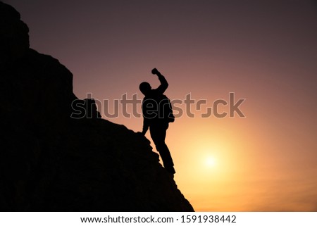 Similar – photographer in mountain at sunset