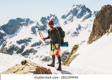 Man climber holding an ice ax on the mountain Traveling Adventure lifestyle concept outdoor extreme mountaineering using mountaineering equipment