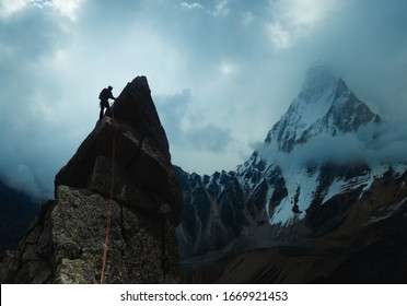 Man Climber Looking For Adventure On Top Of The Mountain