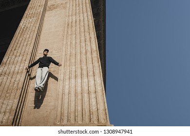 Man climbing between walls. Copy space for your advertising. Street sports concept - Powered by Shutterstock