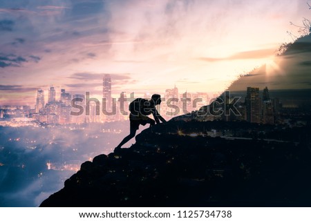 Man climbing up mountain against city background. Reach your life goals and conquer your fears concept. Double exposure. 