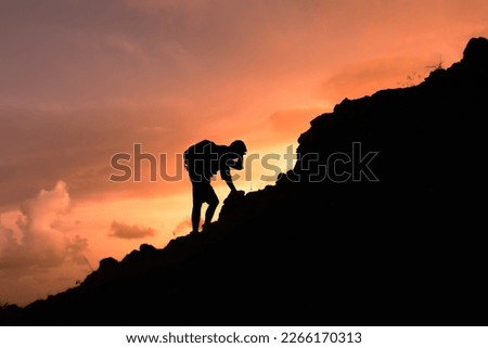 Man climbing up a mountain challenging himself. Overcoming difficulties, life obstacles, problems, struggle, failure concept