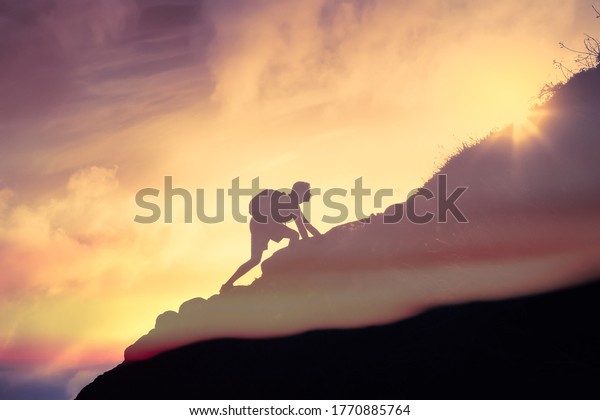 Man climbing up a mountain. Motivation, and inspiration
concept. 