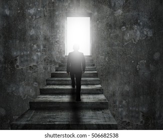 Man Climbing Old Concrete Stairs Toward Open Door With Bright Light.