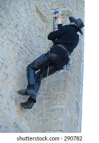 man climbing up the wall