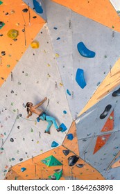 A Man Climbs A Climbing Wall, A Climber Is Training On Artificial Terrain, Rock Climbing In The City, A Strong Man, Sports In The City, Safety In Extreme Sports.