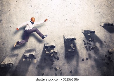 Man climbs the steps of collapsing ladder - Shutterstock ID 352566386