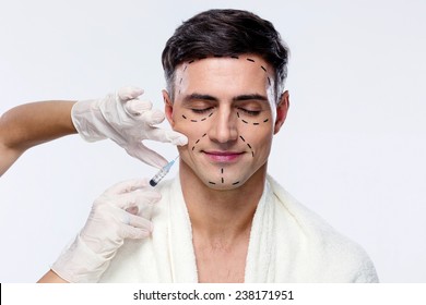 Man With Closed Eyes At Plastic Surgery With Syringe In His Face