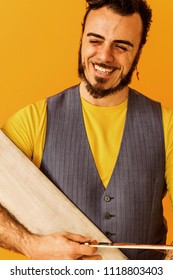 Man Closeup Portrait Holding Musical Saw And Smiling Widely