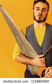 Man Closeup Portrait Holding Musical Saw And Looking At Camera