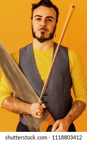 Man Closeup Portrait Holding Musical Saw And Smiling