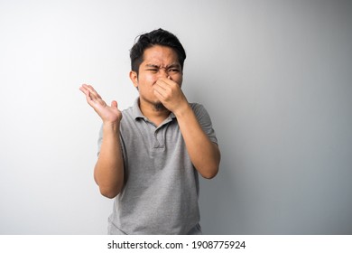 Man Closing Nose, Stink Face Expression. Isolated Portrait Selective Focus.