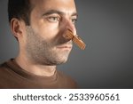 Man with clothespin on his nose.