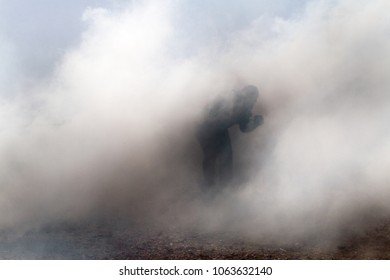 Man in a cloud of smoke