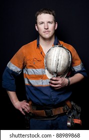 Man With Coal Miner Hat And Safety Clothing, Black Background