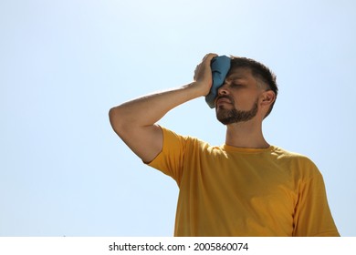 Man with cold pack suffering from heat stroke outdoors - Shutterstock ID 2005860074