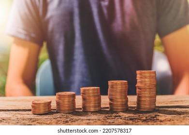 Man collating coins. The concept of financial growth. - Shutterstock ID 2207578317