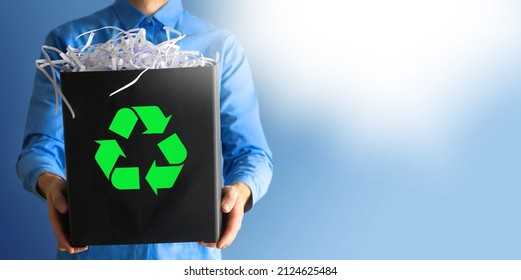 A Man Collecting And Separating Recyclable Garbage Papper Into A Trash Bin At Office. Business Man Holding Recycling Paper. Recycling, Waste Sorting And Sustainability Concept - Happy Smiling Young Wo