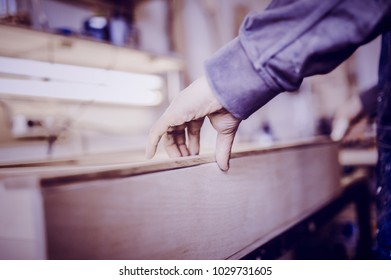 Man collects furniture details in the carpentry shop. Toned image. Gluing furniture parts using glue. close up view - Shutterstock ID 1029731605
