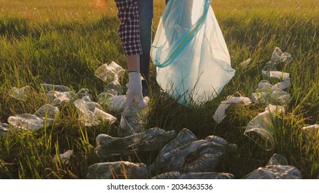 Man Collects Garbage In A Trash Bag, Volunteer Work To Clean Up The Green Planet, Do Good, Eco, Teenager Save The Environment, Work In Protective Rubber Gloves, Plastic Bottle Collection