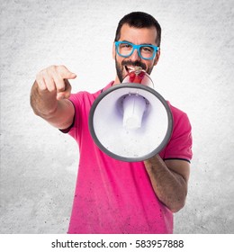 Man With Colorful Clothes Shouting By Megaphone On Grey Textured Background