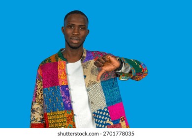 Man in colorful patchwork jacket showing negative emotion with hand gesture