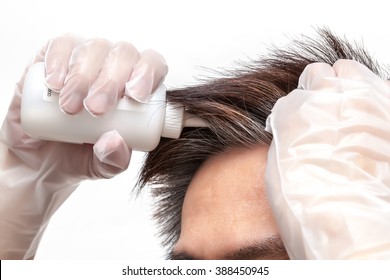 A Man Is Coloring His Grey Hair On White Background