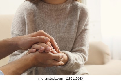Man comforting woman on light background, closeup of hands. Help and support concept
