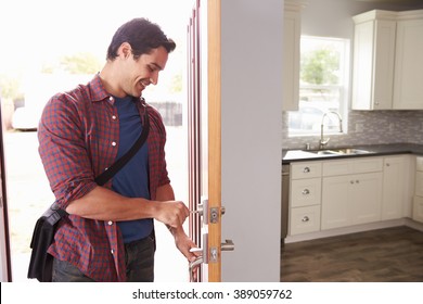 Man Coming Home From Work And Opening Door Of Apartment