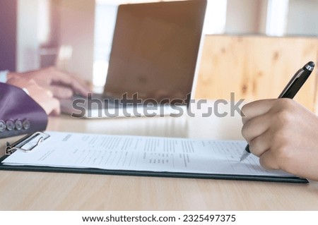 Man Completing Application Form during job interview. human resources concept