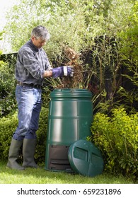 Man Composting In Backyard