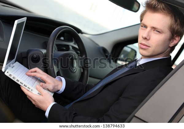 Man with computer in\
car