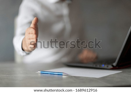 Man at the computer making gestures with his hands