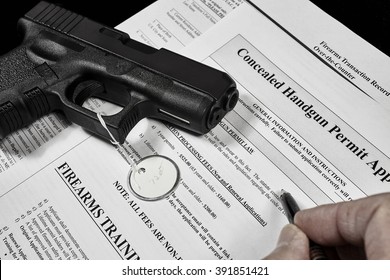 man with concealed carry permit application and pistol gun firearm