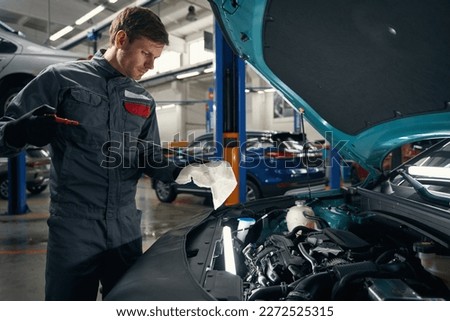Man conducts full technical inspection of machine