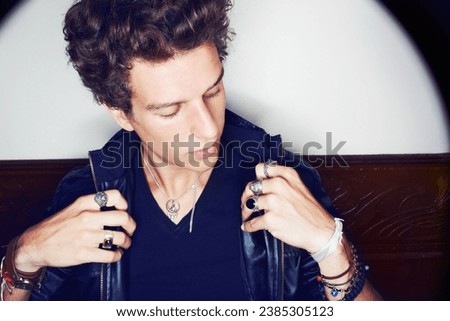 Man with confidence, punk fashion and rock attitude in leather jacket with spotlight. Cool rockstar style, modern grunge and thinking, handsome male model with designer clothes, jewellery and culture