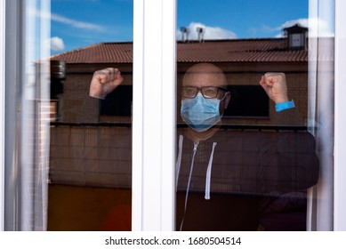 Man confined to his home in quarantine because of Covid-19 - Shutterstock ID 1680504514