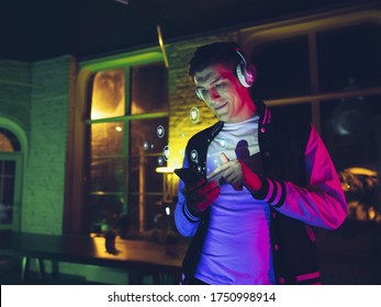 Man connecting and sharing with social media, listen to music with headphones, gets likes. Modern UI icons, communication, devices. Concept of modern technologies, networking, gadgets. Design. - Powered by Shutterstock