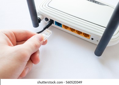 Man Connects Internet Cable In The Router