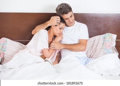 Man Consoles His Wife Lying Bed In Bedroom, Couple Consoling, Husband Embrace Comforts His Woman