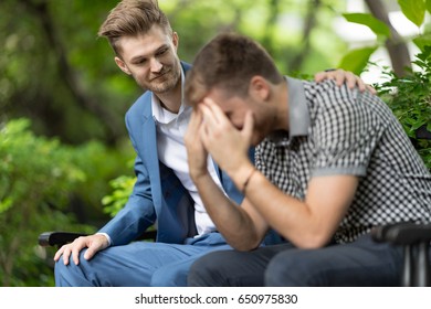 Man Consoling Sadness Friend He Closing His Face, Crying And Feeling Upset Cause From His Mistake In The Park.Breakup Concept